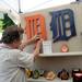 Craftsman Robert Koss, of Artcraft Furnishings in Farmington Hills, adds a price tag to an old English D for sale at his booth on E. William St. during the State St. Art Fair on Wednesday, July 17, 2013. Melanie Maxwell | AnnArbor.com